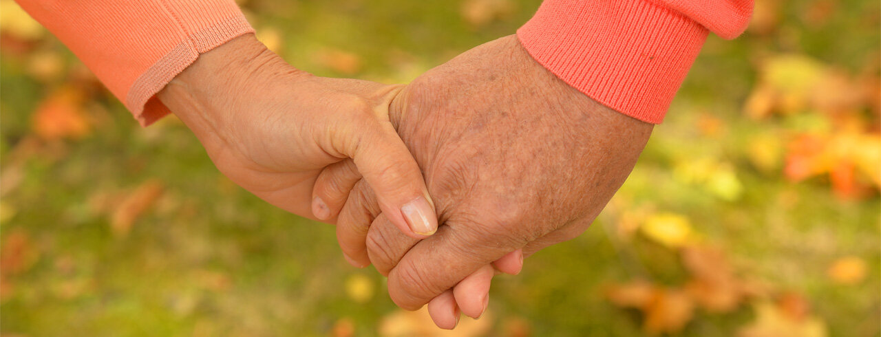 Close-up of two people holding hands