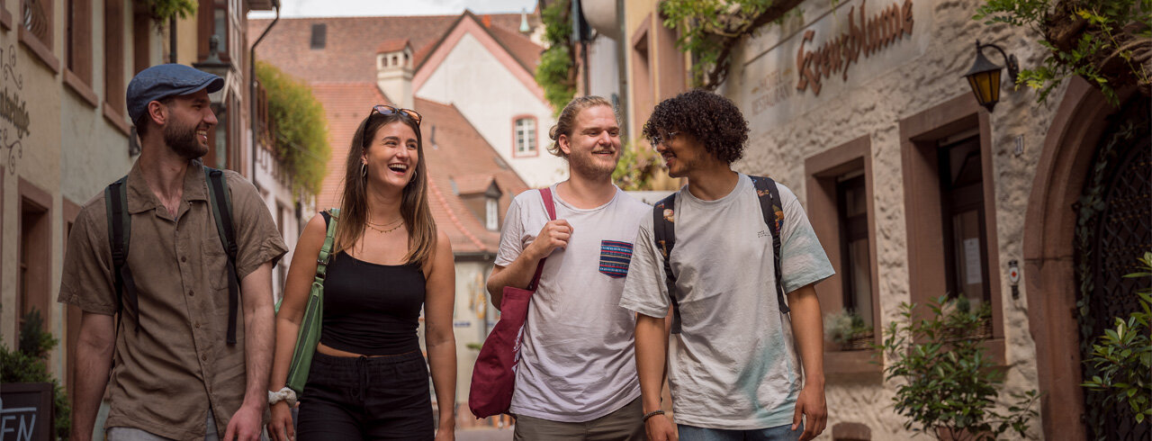 Studierende flanieren im Gespräch durch die Freiburger Innenstadt